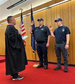 The Honorable Kyle Halesey at Left administers the oath to new Career Firefighters Austin Nocera (Middle) and Ryan Kairo Jr. (Right)